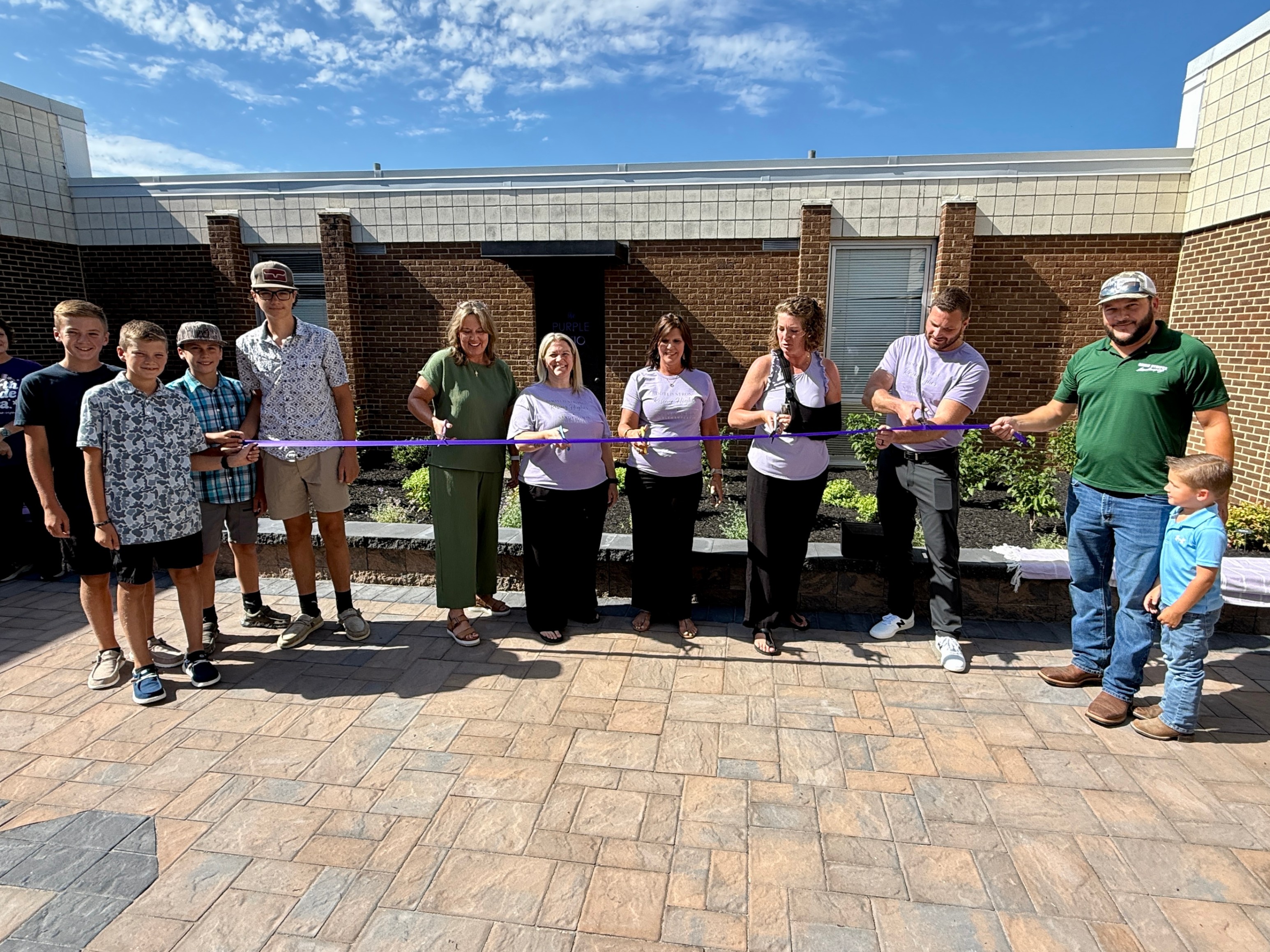 SHES Team Celebrates New Purple Patio